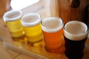 A flight of 4 beers darkening in color from left to right