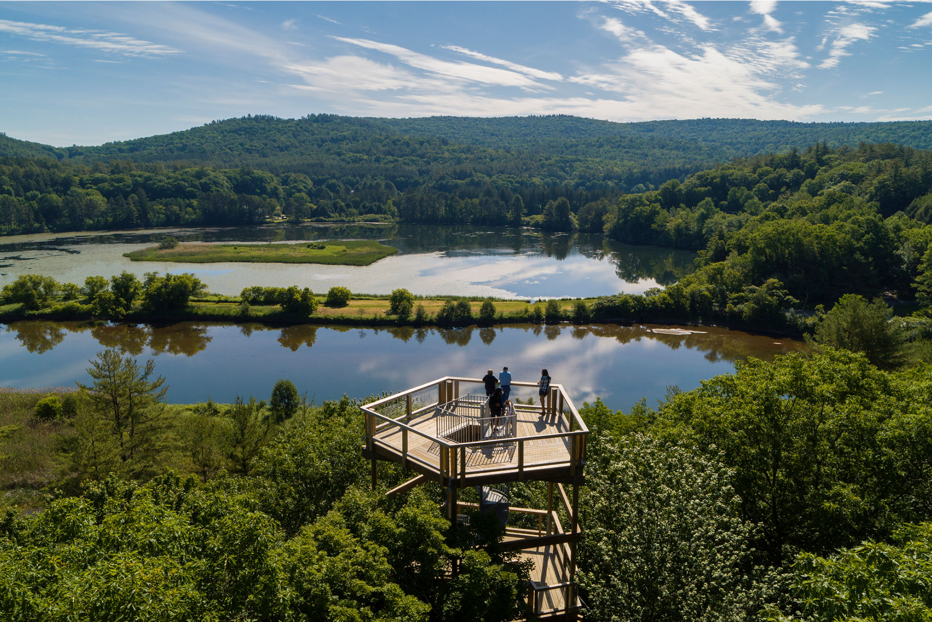 View of a lake with green hills behind from a fire tower